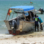 ORANGO ISLAND, GUINEA BISSAU - MAY 3, 2017: Unidentified local people sit on the boat on the coast of the Orange island, part of the Bijagos Archipelago.